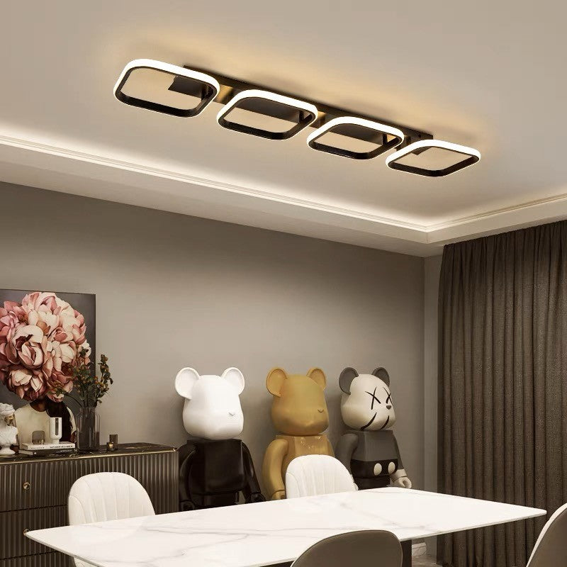 Lustra LED aplicata cu 4 cadre patrate negre, ambientare moderna in sufragerie cu lumina calda
