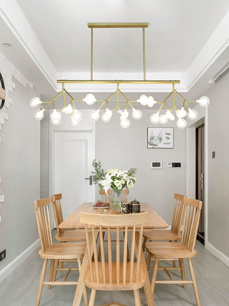 Candelabru LED tip ramuri aurii suspendat deasupra masa dreptunghiulara, iluminare uniforma in sufragerie