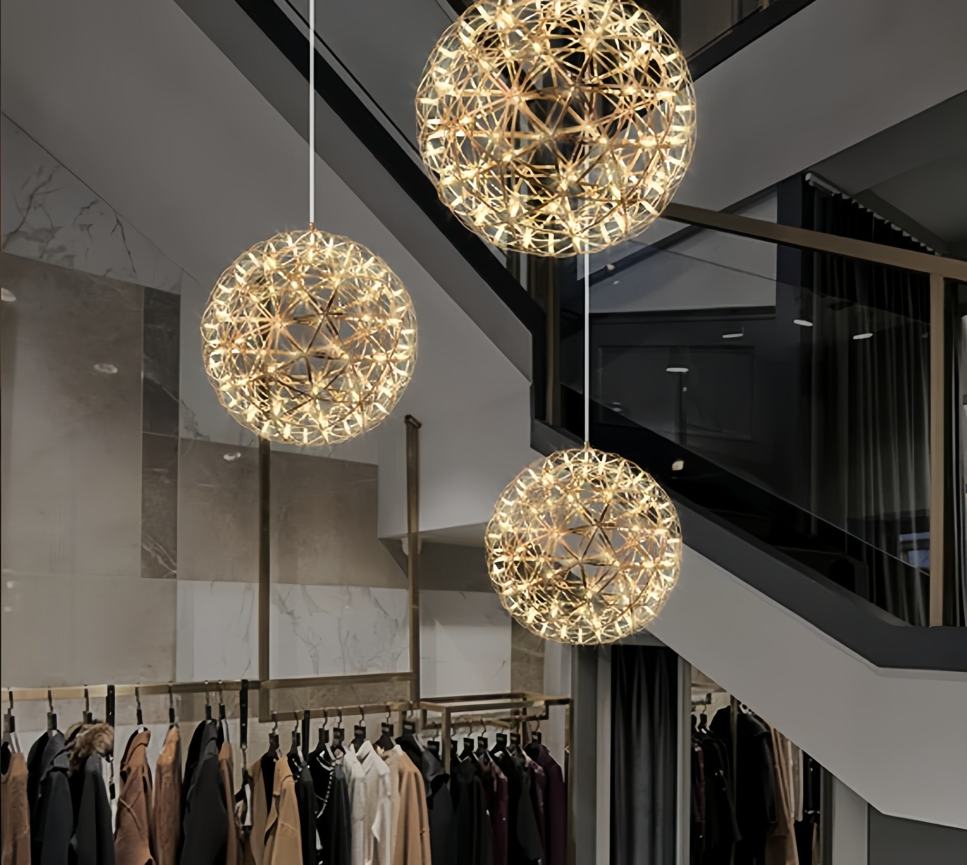 Lustra LED sferica suspendata cu efect geometric, lumina calda 3000K, utilizata in spatiu comercial cu etaj