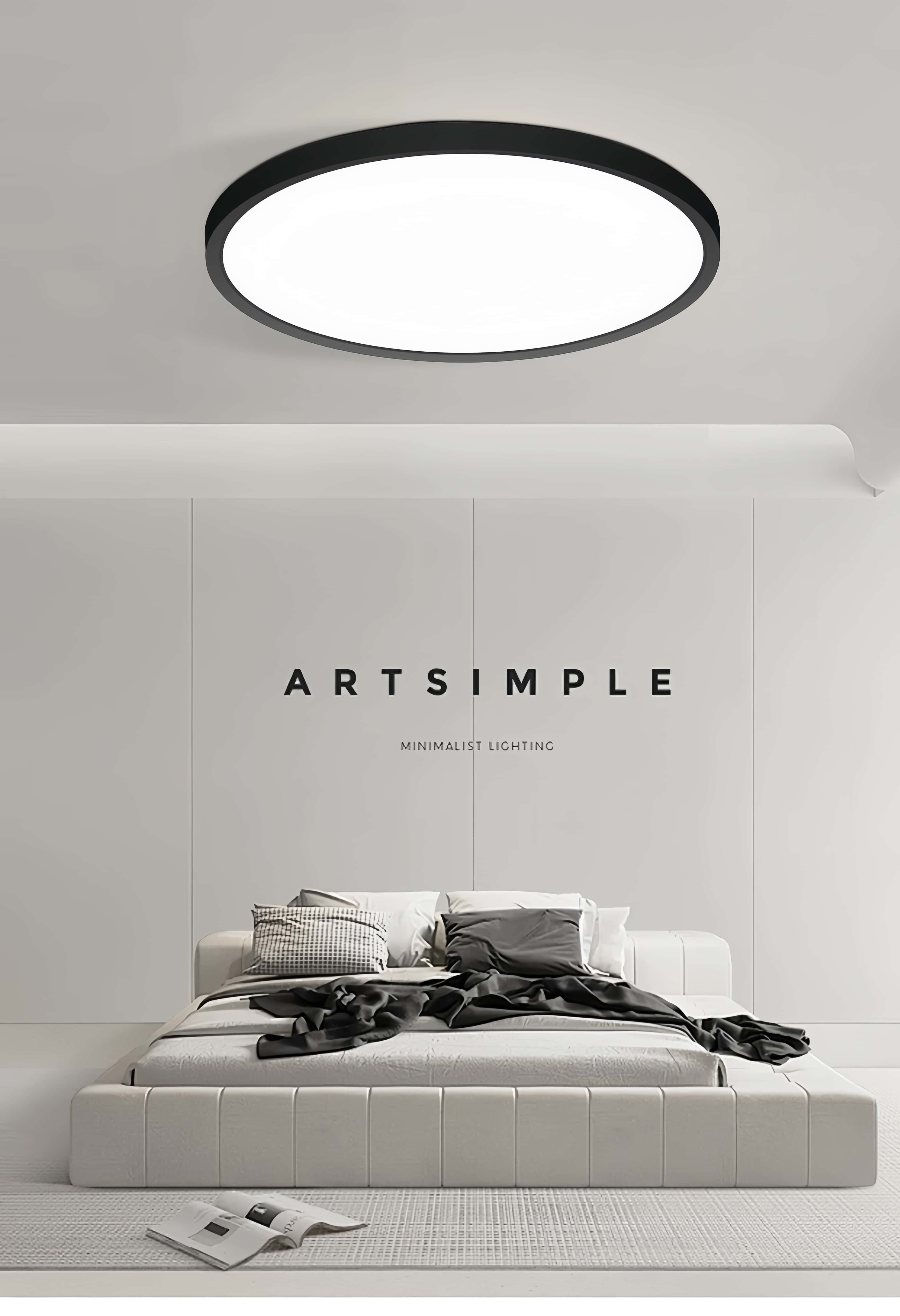 Plafoniera LED rotunda cu rama neagra ultra slim deasupra unui pat, aspect minimalist in dormitor
