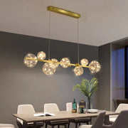 Lustra LED suspendata 70W 3500lm 3000K, bara aurie cu 8 globuri transparente, deasupra masa dining